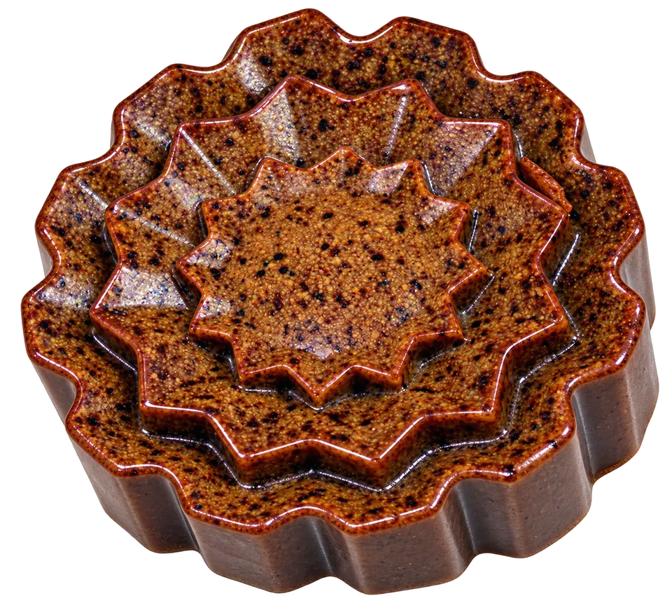 Top view of the oval dark brown herbal soap with a round Cosmeherb sticker.
